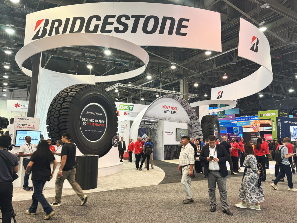 Trade show floor with people walking in and through Bridgestone exhibit at MinExpo